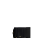 Saint Laurent black calf leather Bos Taurus wallet with gold-tone hardware and multiple card slots.