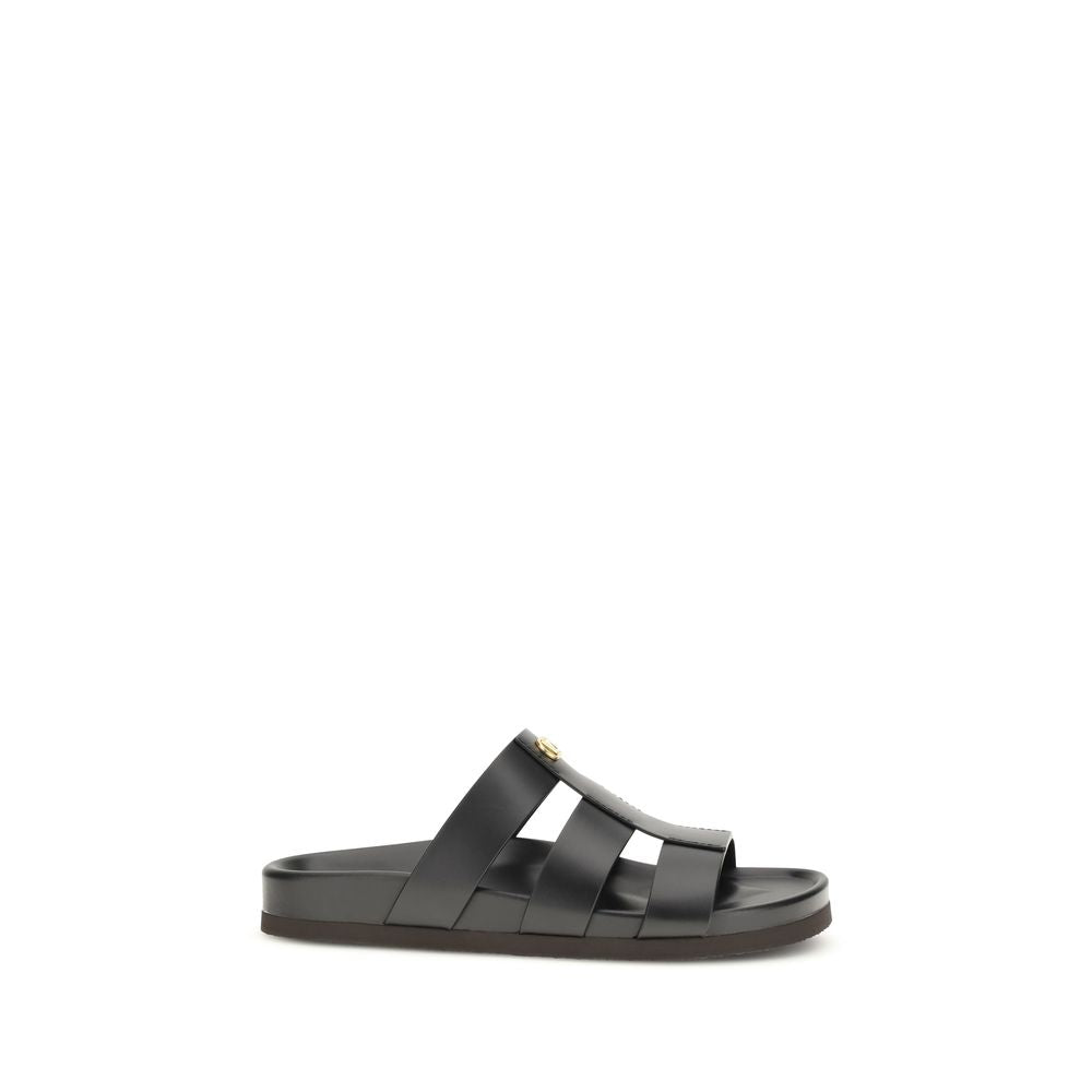 Valentino Garavani black calf leather Bos Taurus sandals with open toe and ankle strap, stylish and luxurious footwear.