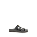 Valentino Garavani black calf leather Bos Taurus sandals with open toe and ankle strap, stylish and luxurious footwear.