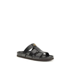 Valentino Garavani black calf leather Bos Taurus sandals with open toes and ankle straps, stylish and luxurious footwear.