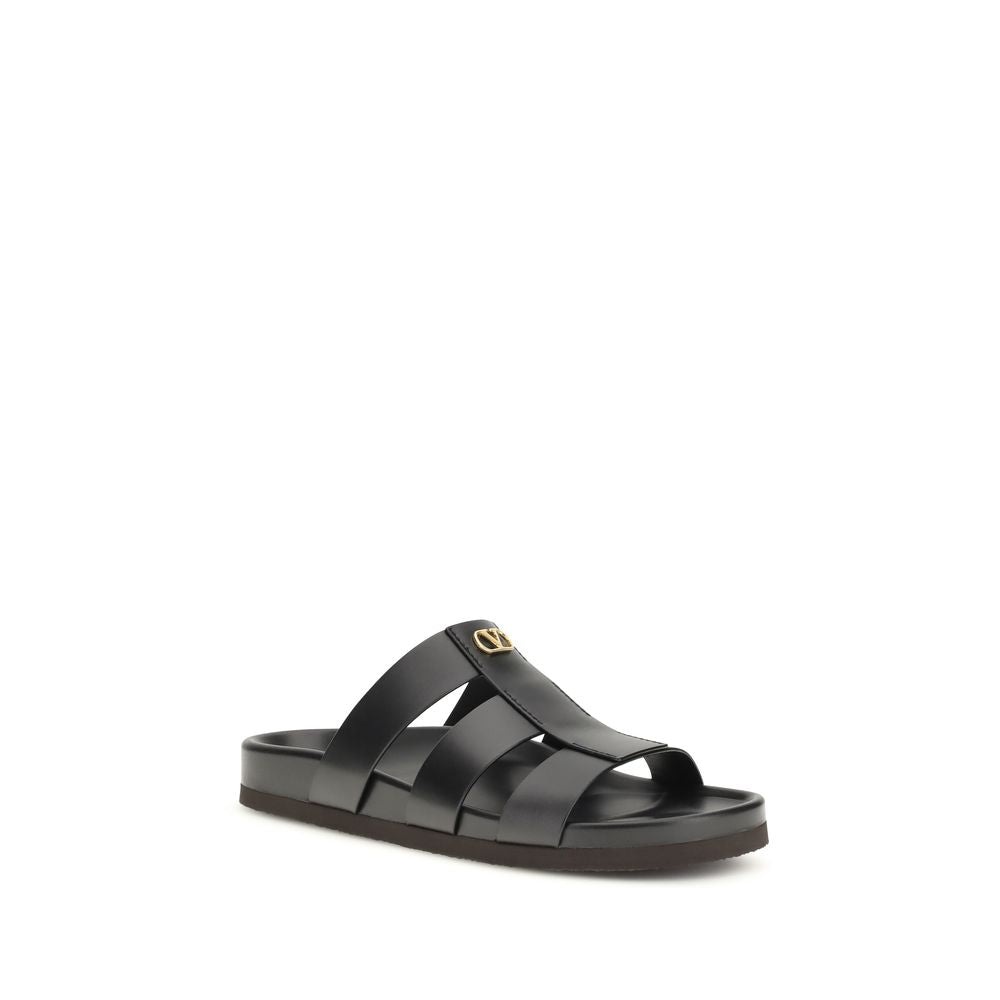 Valentino Garavani black calf leather Bos Taurus sandals with open toes and ankle straps, stylish and luxurious footwear.
