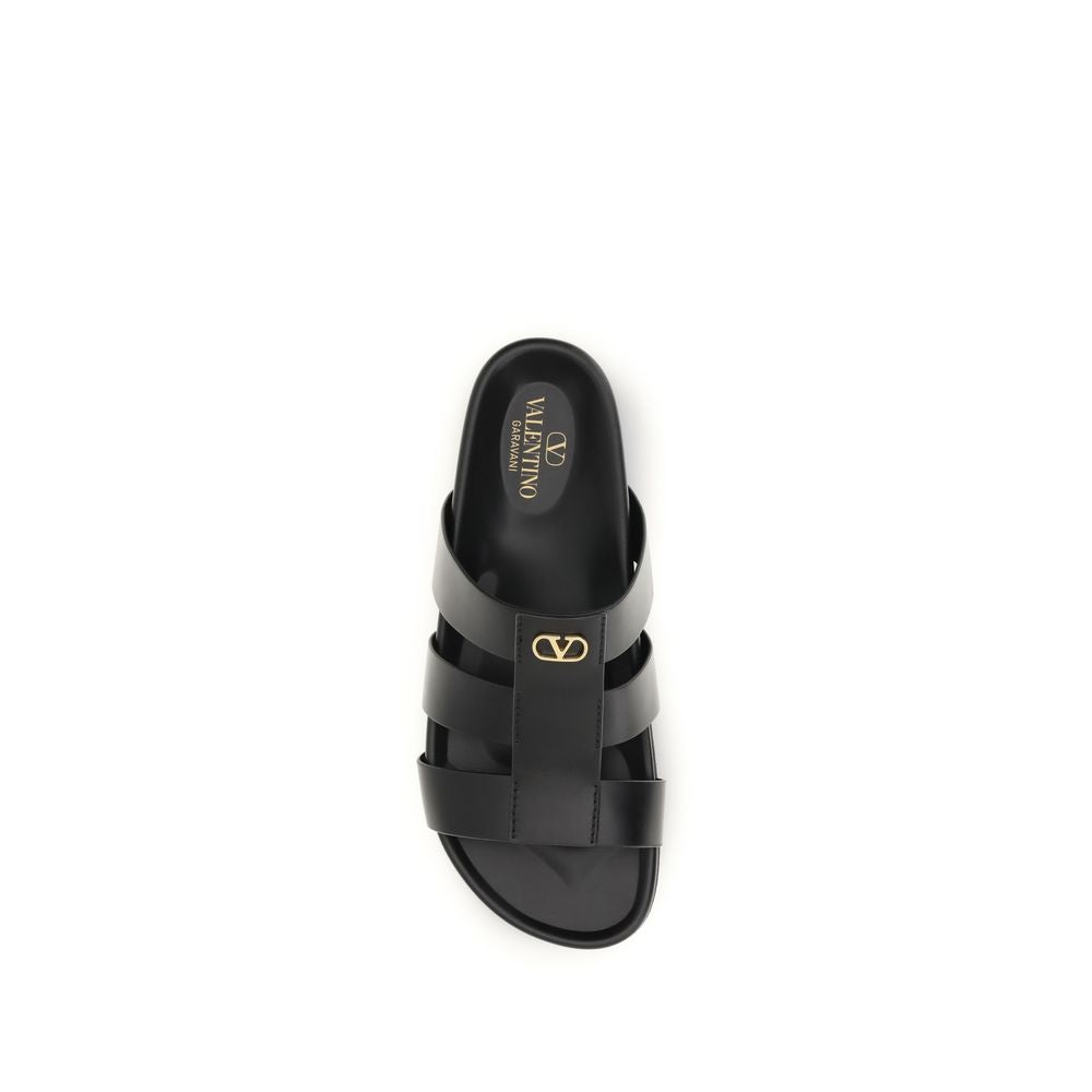 Valentino Garavani black calf leather Bos Taurus sandals with open toe and ankle strap, stylish and elegant footwear.