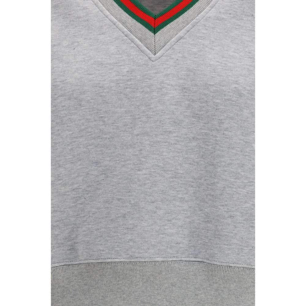 Gray cotton Gucci sweatshirt with logo detail, displayed on a hanger against a plain background.