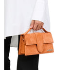 Jacquemus Terracotta Leather Le Grand Bambino handbag with top handle and gold-tone hardware, showcasing its structured design.