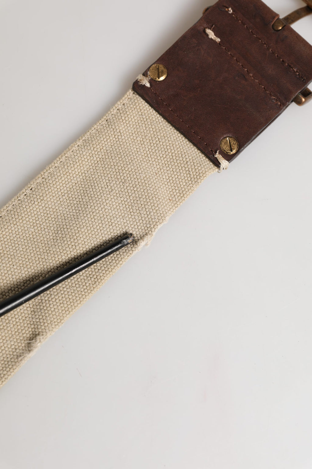 Beige and brown leather canvas belt with metal buckle from Ermanno Scervino, displayed on a neutral background.