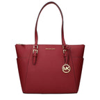 Red leather shoulder bag by Michael Kors with gold hardware and adjustable strap, featuring a sleek, stylish design.
