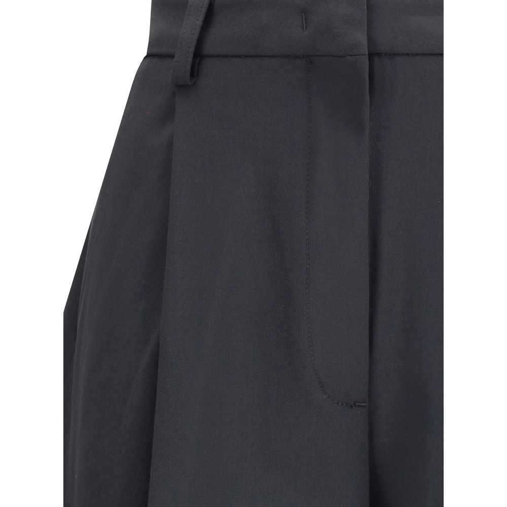 Black polyester casual pants from The Latest, featuring a relaxed fit and modern style, shown on a model.