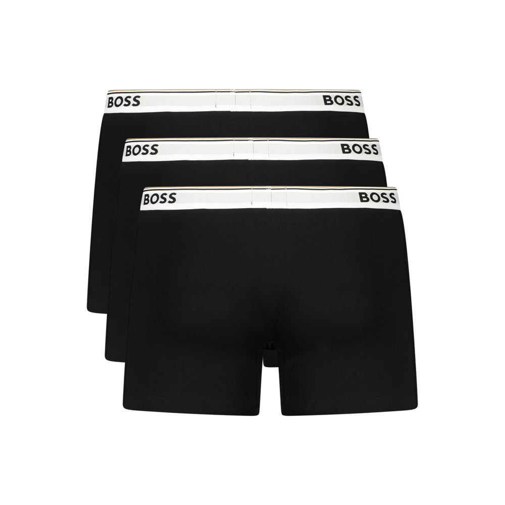Hugo Boss black cotton men's boxer shorts with elastic waistband and branding, displayed flat on a white background.