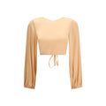Kristina Ti orange silk blouse with a relaxed fit, featuring a V-neckline and long sleeves, displayed on a hanger.