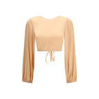 Kristina Ti orange silk blouse with a relaxed fit, featuring a V-neckline and long sleeves, displayed on a hanger.