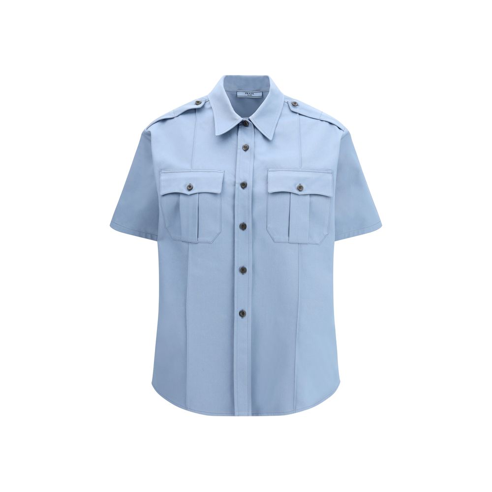 Prada blue cotton shortsleeve shirt displayed on a hanger, showcasing a casual, stylish men's top with a classic collar and short sleeves.