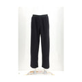 Black cotton casual pants by MM6, featuring a relaxed fit and minimalist design, shown on a model.
