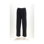 Black cotton casual pants by MM6, featuring a relaxed fit and minimalist design, shown on a model.