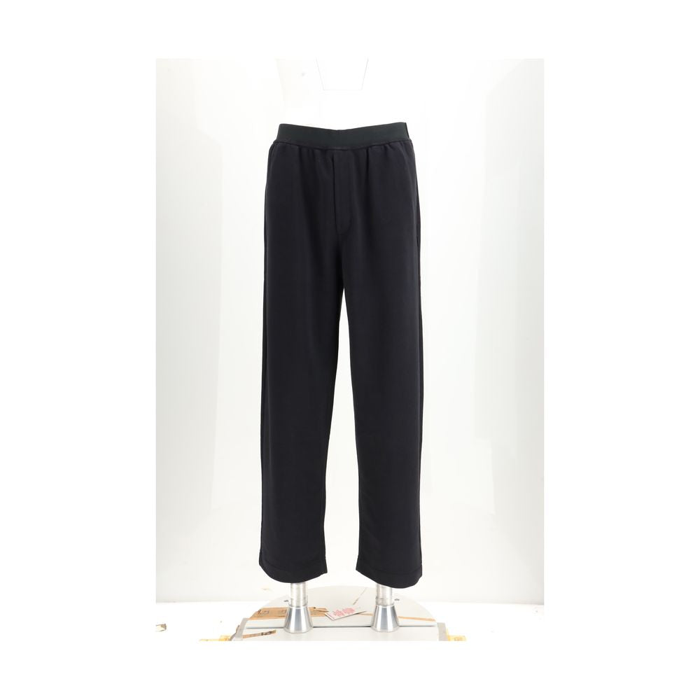 Black cotton casual pants by MM6, featuring a relaxed fit and minimalist design, shown on a model.