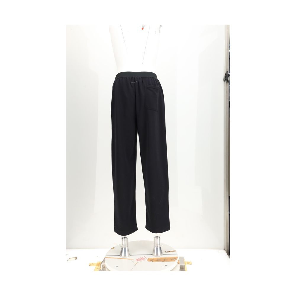 Black cotton casual pants by MM6, featuring a relaxed fit and minimalist design, shown on a plain background.