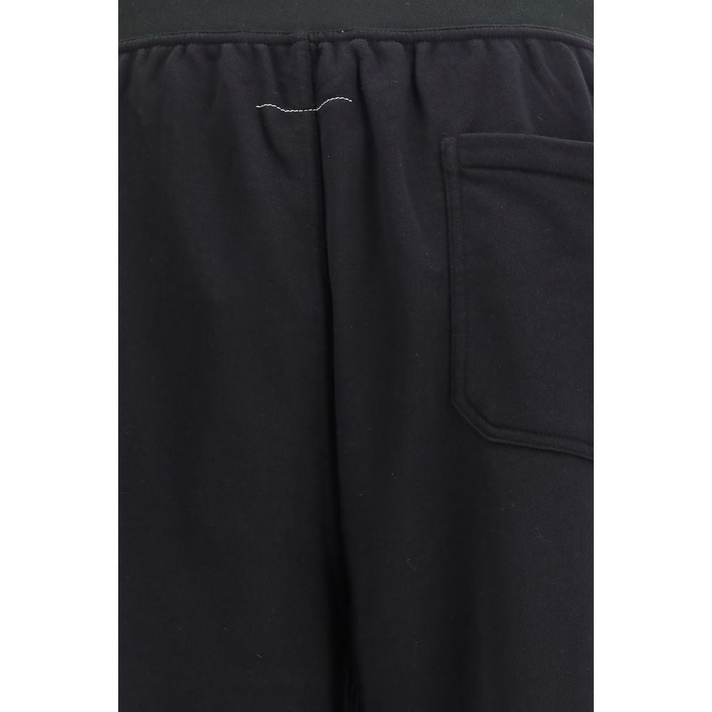 Black cotton casual pants by MM6, featuring a relaxed fit with pockets and a comfortable waist, ideal for everyday wear.