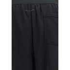 Black cotton casual pants by MM6, featuring a relaxed fit with pockets and a comfortable waist, ideal for everyday wear.