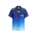 Casablanca blue silk patterned shirt with button-up front and classic collar, displayed on a hanger.