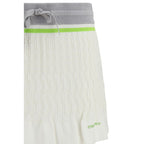 Casablanca white cotton mini skirt displayed on a hanger, showcasing lightweight fabric and simple, elegant design.