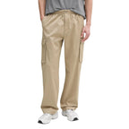 Beige cotton cargo pants by Calvin Klein Jeans with multiple pockets and a relaxed fit, suitable for casual wear.