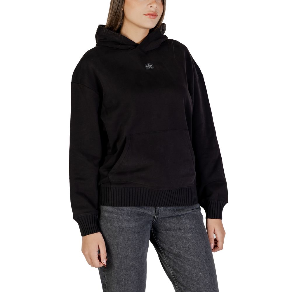 Black cotton hoodie from Calvin Klein Jeans with logo detail, casual fit, and drawstring hood, displayed on a hanger.