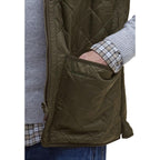 Barbour green polyamide sleeveless jacket displayed on a hanger, showcasing lightweight outdoor wear with a zip closure and stand collar.