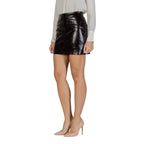 Jacqueline De Yong brown polyester mini skirt with a fitted waist and short hem, styled on a model.