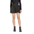 Black polyester mini skirt from Jacqueline De Yong, showing a close-up of the fitted waist and smooth fabric texture.