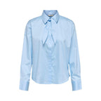 Jacqueline De Yong blue cotton blouse with long sleeves and a relaxed fit, displayed on a hanger against a white background.
