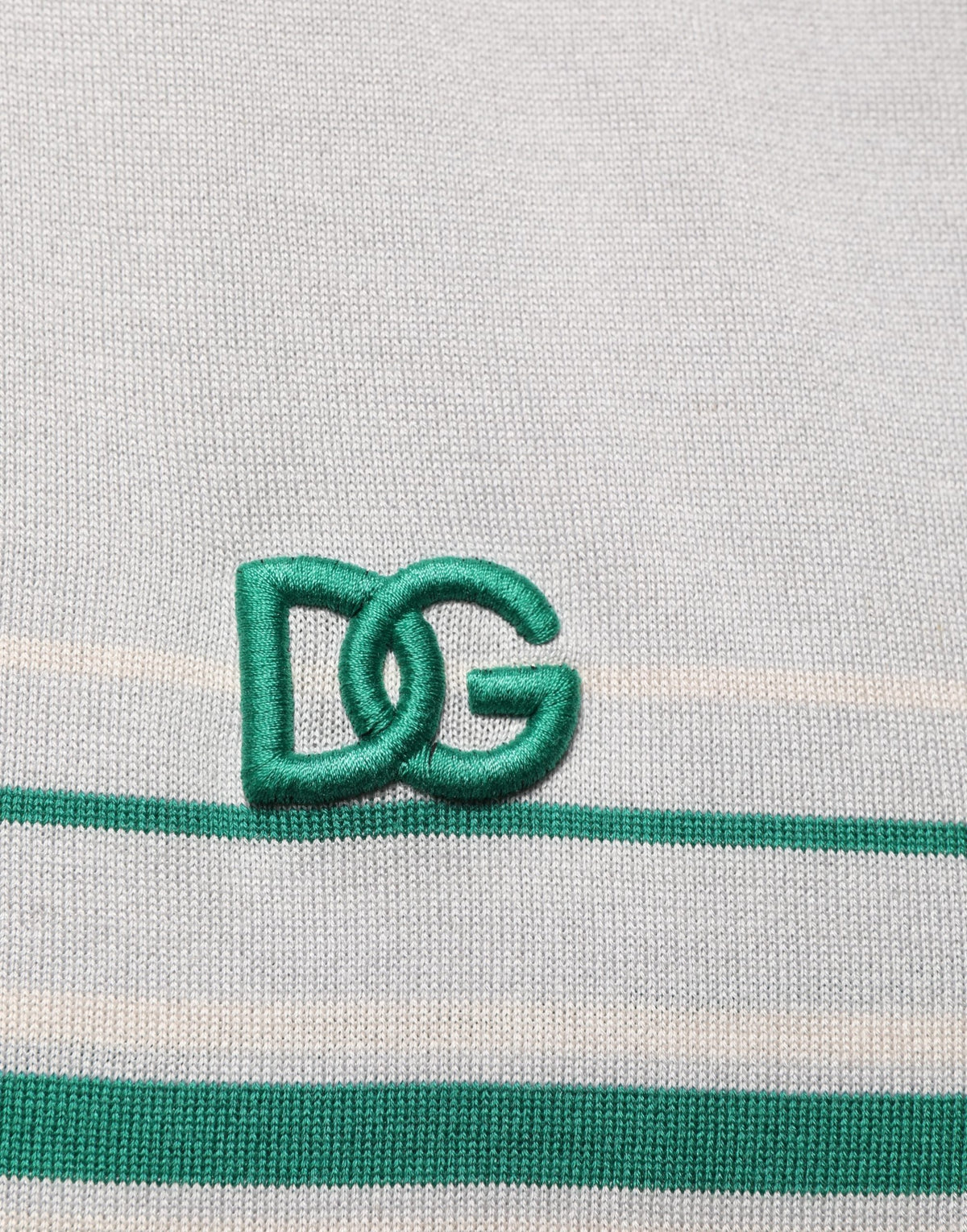 Dolce & Gabbana gray and green striped logo silk polo T-shirt displayed on a hanger with visible collar and branding details.