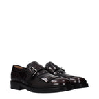 Church's red leather slip-on loafers showing smooth leather surface and classic loafer design on a plain background.