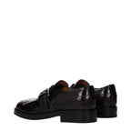 Church's red leather slip-on loafers displayed on a neutral background, showcasing their sleek design and polished finish.