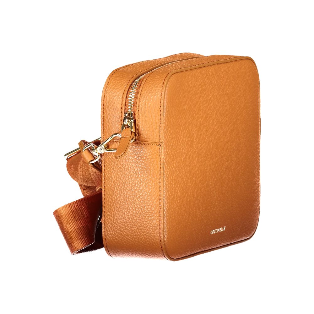 Orange leather Coccinelle women's handbag with sleek design and top handle, showcasing elegant craftsmanship and spacious interior.
