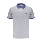 Timberland blue men's cotton polo shirt displayed on a hanger, featuring a classic collar and button placket.