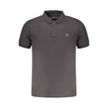 Black Timberland men's cotton polo shirt with a classic collar and short sleeves, displayed on a hanger.