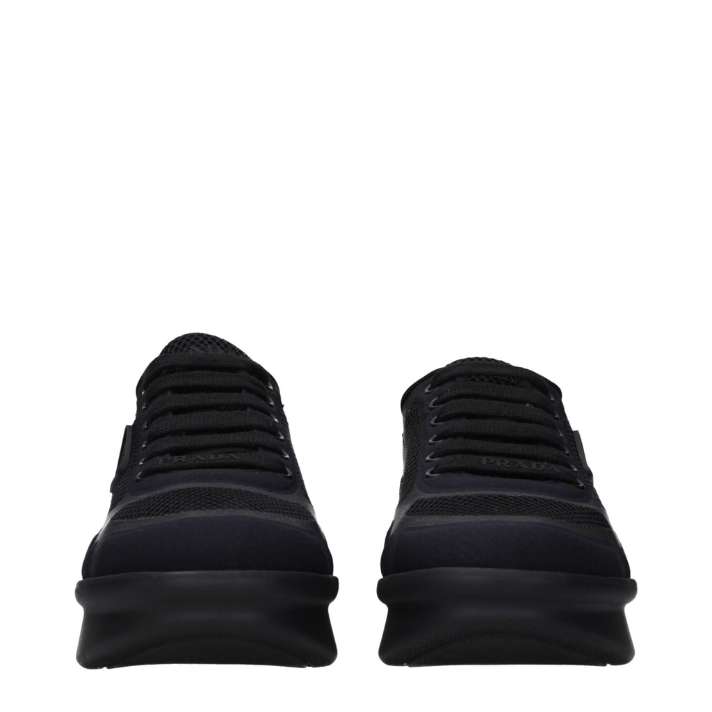 Prada black fabric low top sneakers with white soles and subtle branding, displayed on a neutral background.