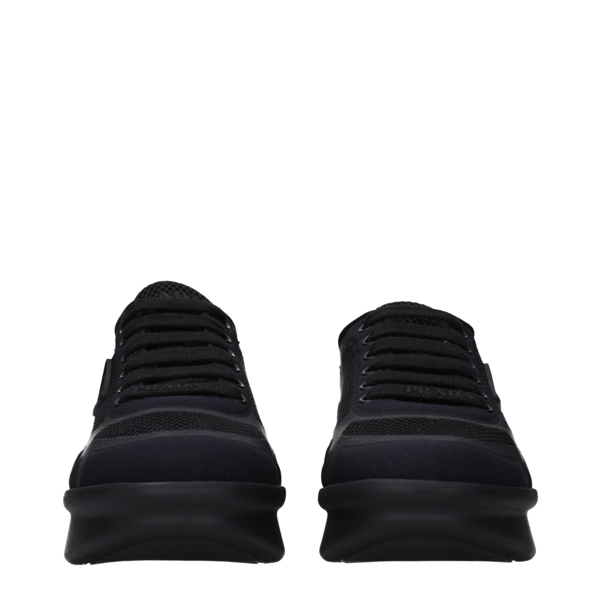 Prada black fabric low top sneakers with white soles and subtle branding, displayed on a neutral background.