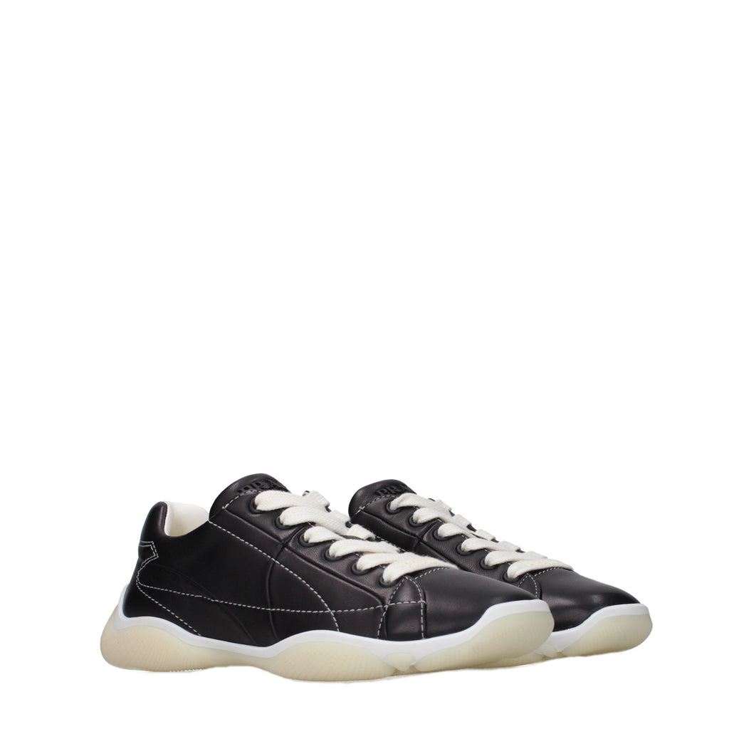 Prada black leather sneakers with sleek design and white rubber soles, showcasing stylish and comfortable footwear.
