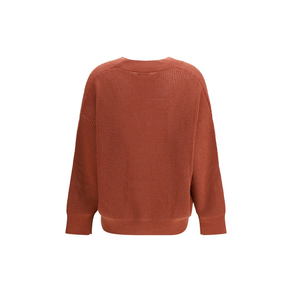 Brunello Cucinelli orange cashmere cardigan displayed on a hanger, showcasing soft, luxurious knit fabric and classic design.