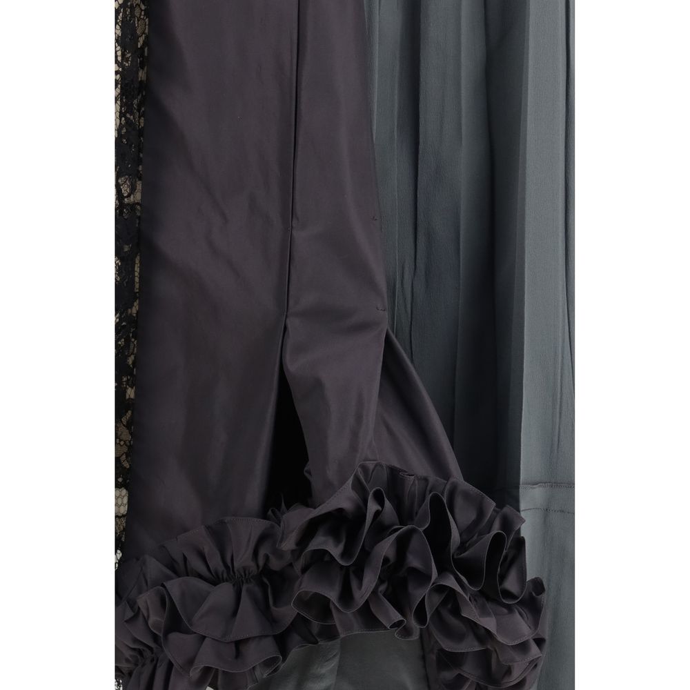 Prada multicolor silk midi skirt with flowing fabric and vibrant pattern, displayed on a neutral background.