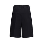 Black cotton Bermuda shorts by GCDS with a relaxed fit and stylish design, shown on a model.