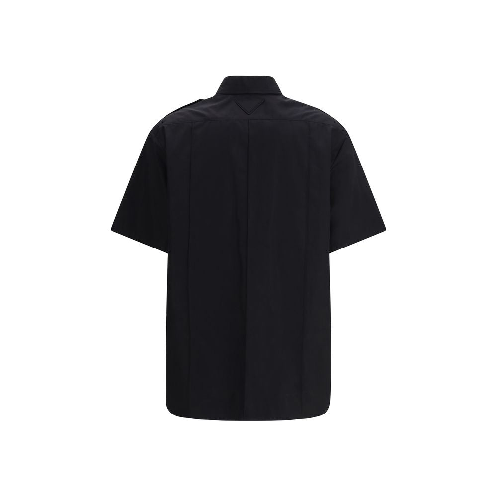 Prada black cotton short-sleeve shirt with a classic collar and button-front design, displayed flat on a neutral background.