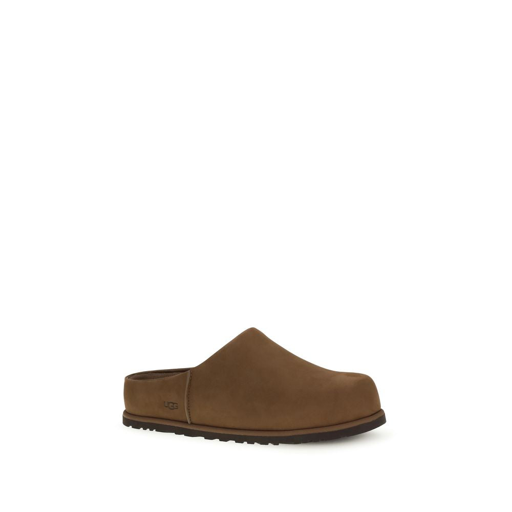 Brown calf leather UGG Bos Taurus mules featuring a sleek design and comfortable slip-on style.