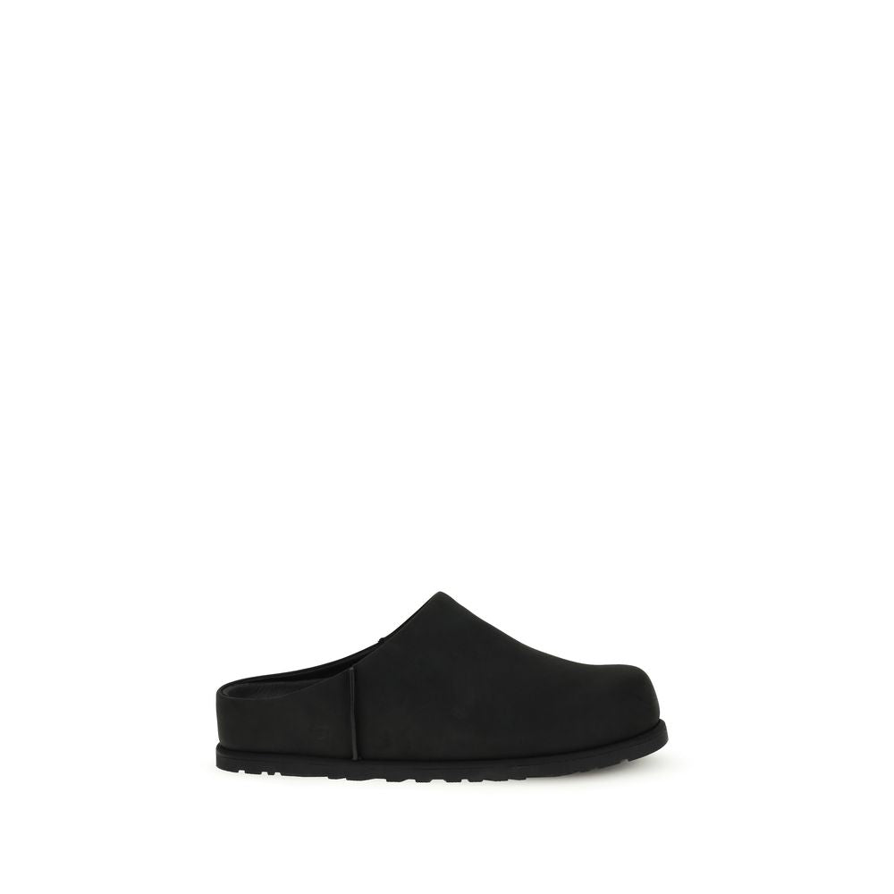 Black calf leather UGG Bos Taurus mules with slip-on design and pointed toe, showcasing stylish and comfortable women's footwear.