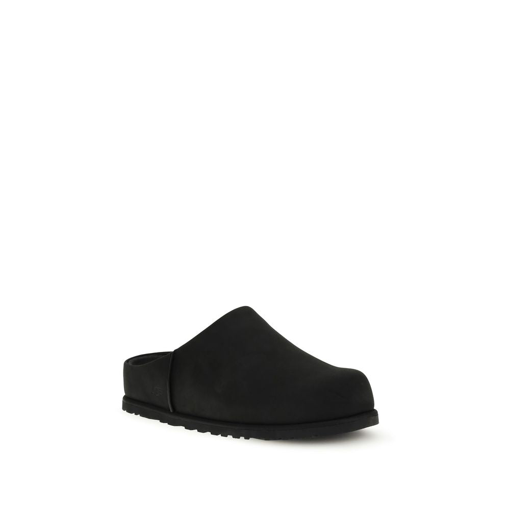 UGG black calf leather Bos Taurus mules with pointed toes and slip-on design, showcasing stylish and sleek footwear.