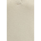 Beige cashmere polo shirt by Gabriela Hearst displayed on a hanger, showcasing soft texture and classic fit.