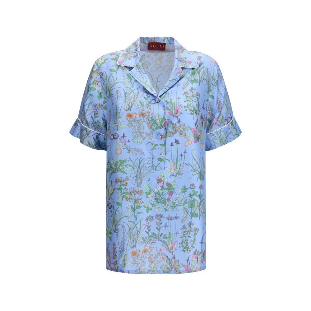 Gucci blue silk patterned shirt with long sleeves and classic collar, showcasing elegant design and luxurious fabric.