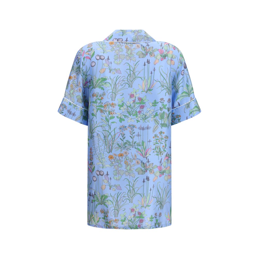 Gucci blue silk patterned shirt with long sleeves and button-up front, featuring a stylish and luxurious design.