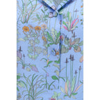 Gucci blue silk patterned shirt with long sleeves and button-down front, showcasing elegant fabric and stylish design.