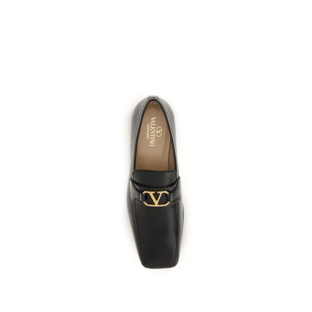 Valentino Garavani black goatskin slip-on loafers with sleek design and minimal stitching, perfect for elegant casual wear.